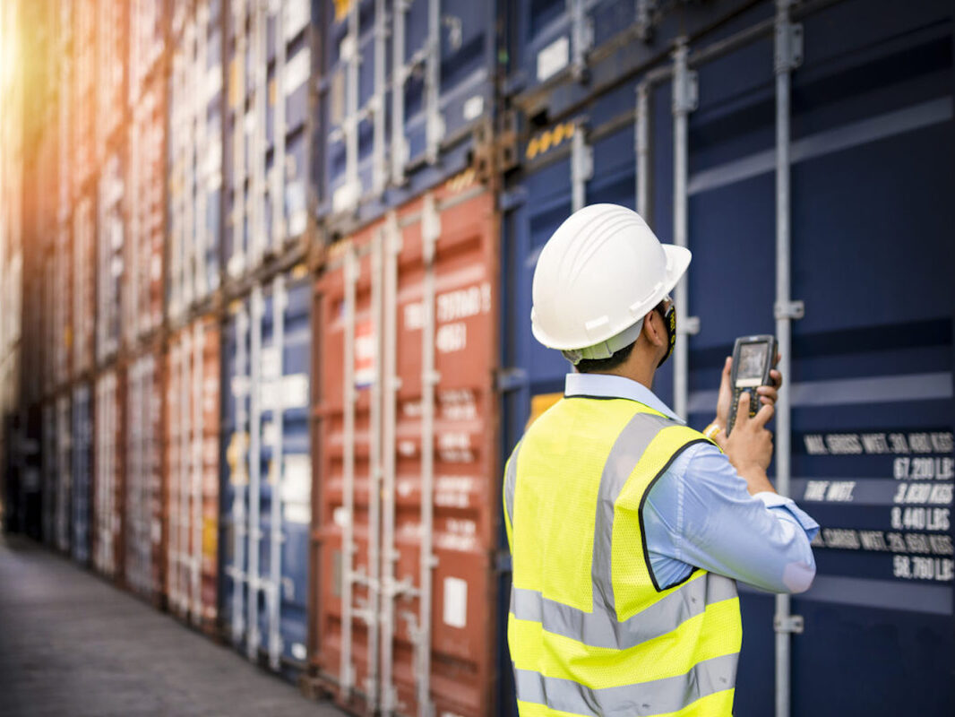 Logistics professional inspecting containers
