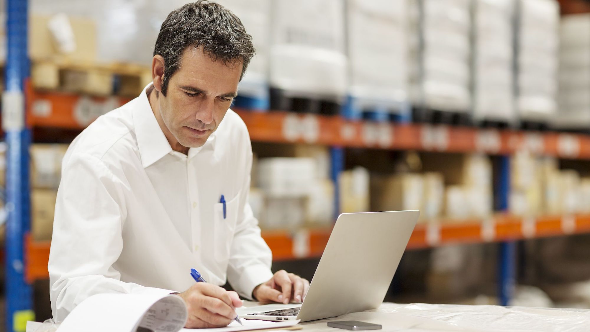 Logistics professional reviewing shipment documents